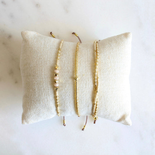 Adjustable beaded bracelet set in beige.